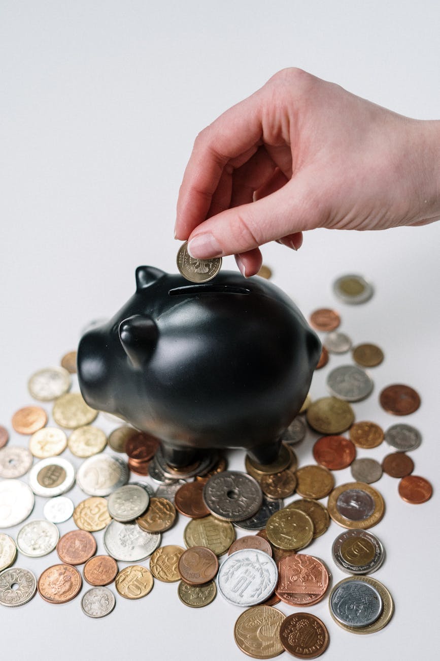 Woman smiling while organizing coins and bills into labeled jars.